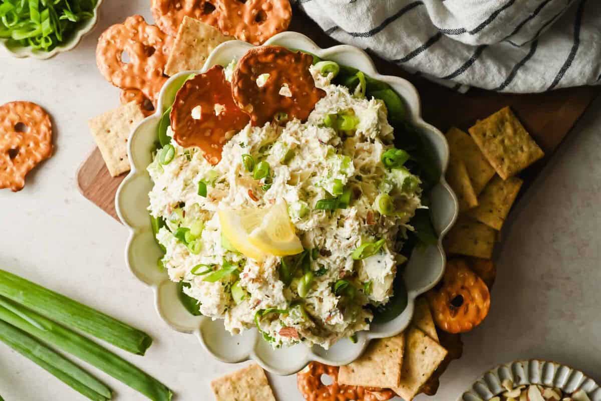 Finished Boursin chicken salad spread served with crunchy crackers and pretzels.