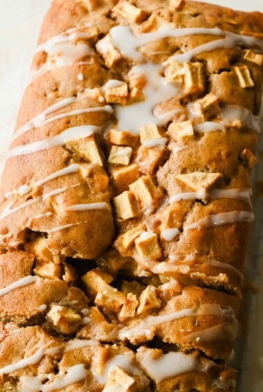 Close-up of powdered sugar glaze drizzled over apple fritter bread