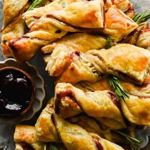 Golden blackberry and Boursin puff pastry twists on a serving platter.