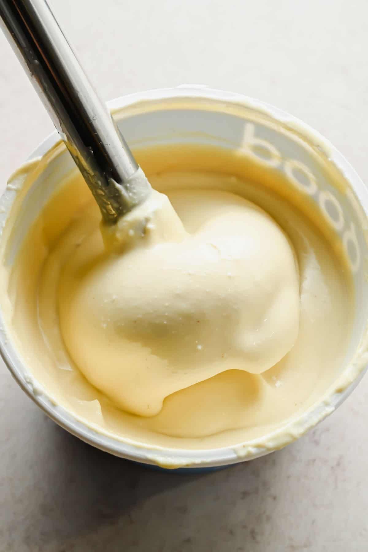 Smooth blended cottage cheese honey mustard dip on a spoon.